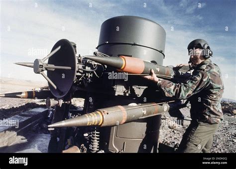 A Member Of The Royal Air Force Regiment Loads A Rapier Missile Into A Member Of The Royal Air Force Regiment Loads A Rapier Missile Into