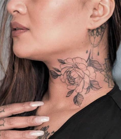 A Woman Amp 39 S Neck With A Rose Tattoo On It